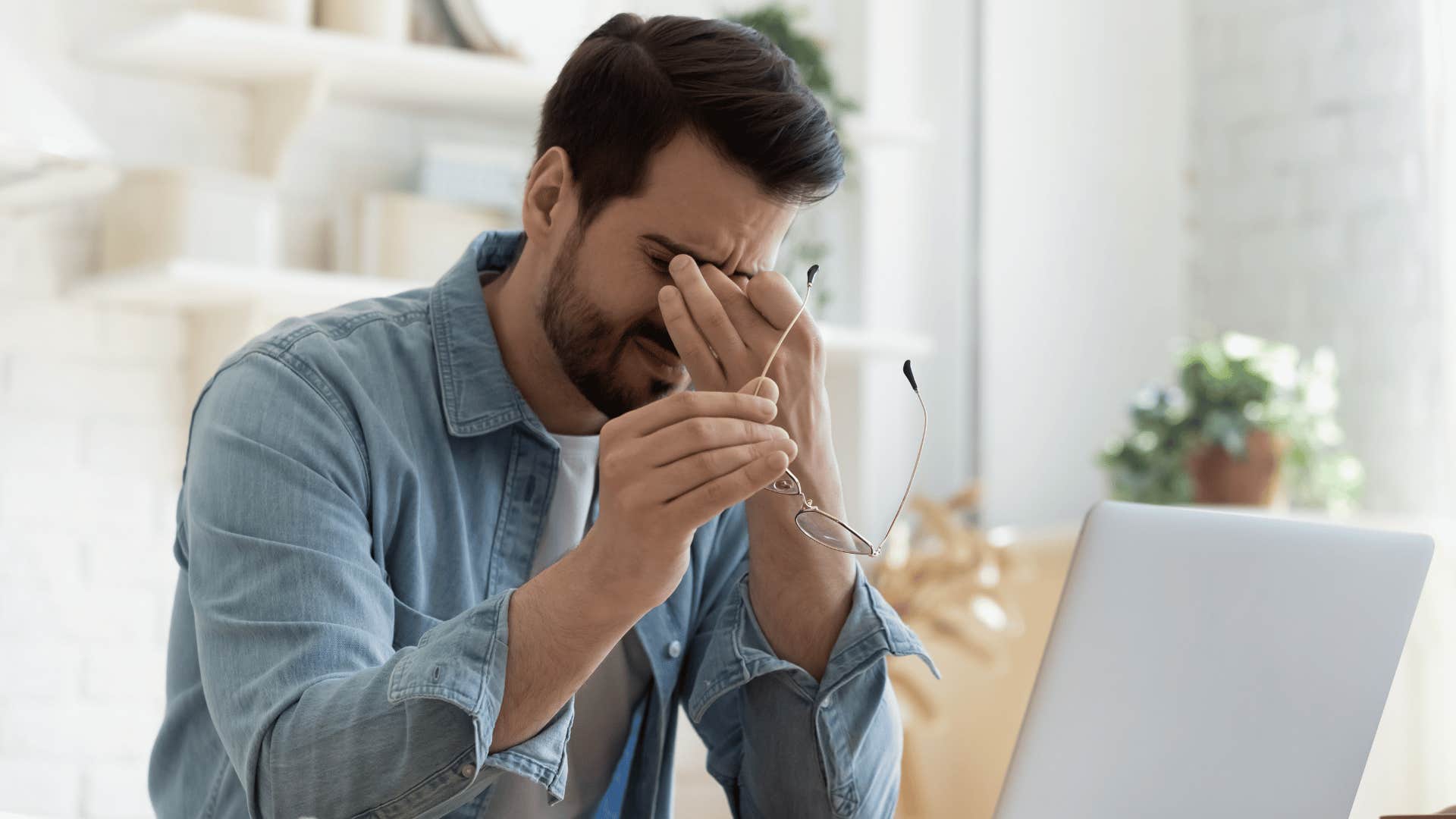 tired man in front of laptop