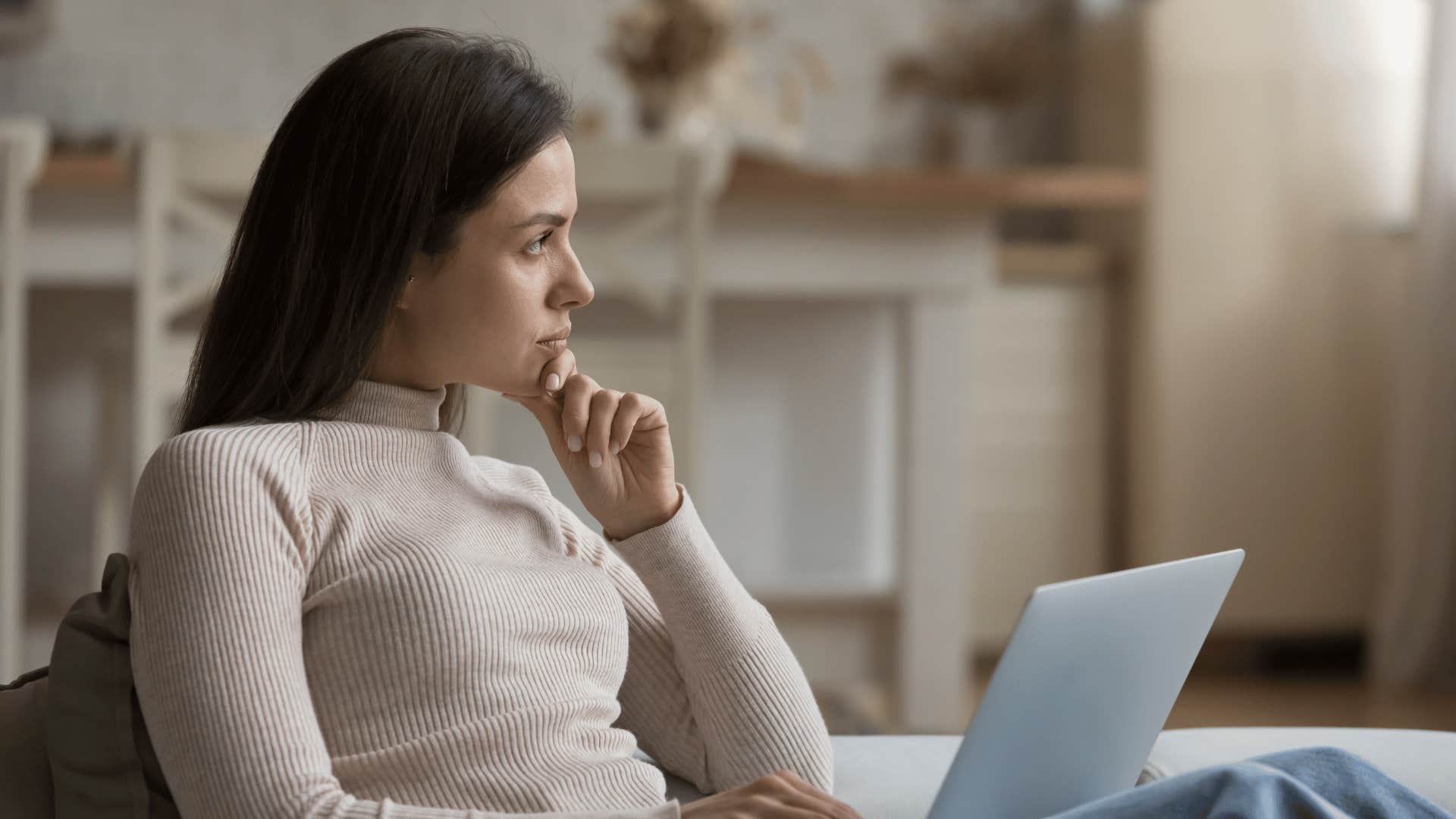 woman with laptop thinking