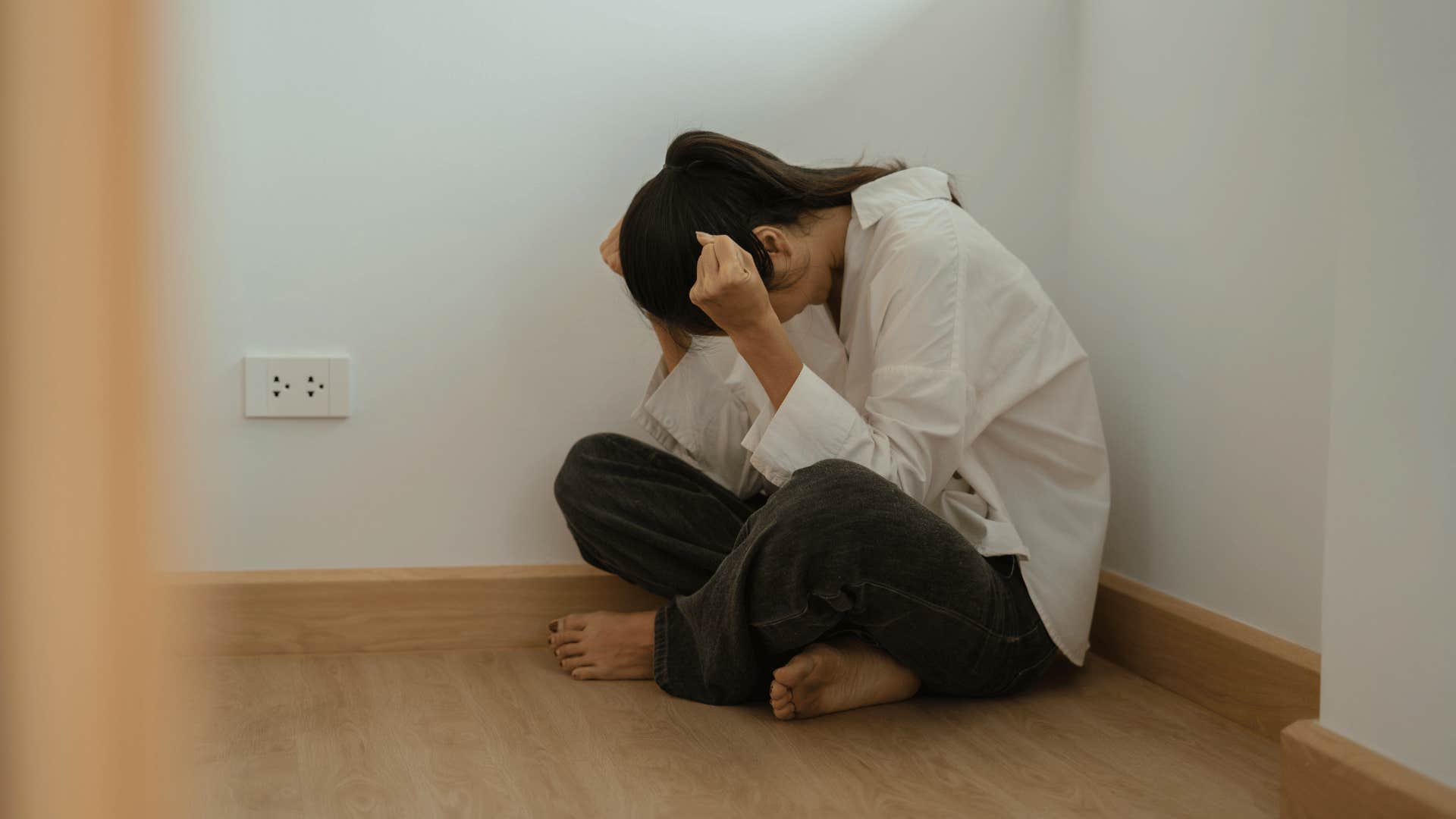 upset woman sitting on the floor