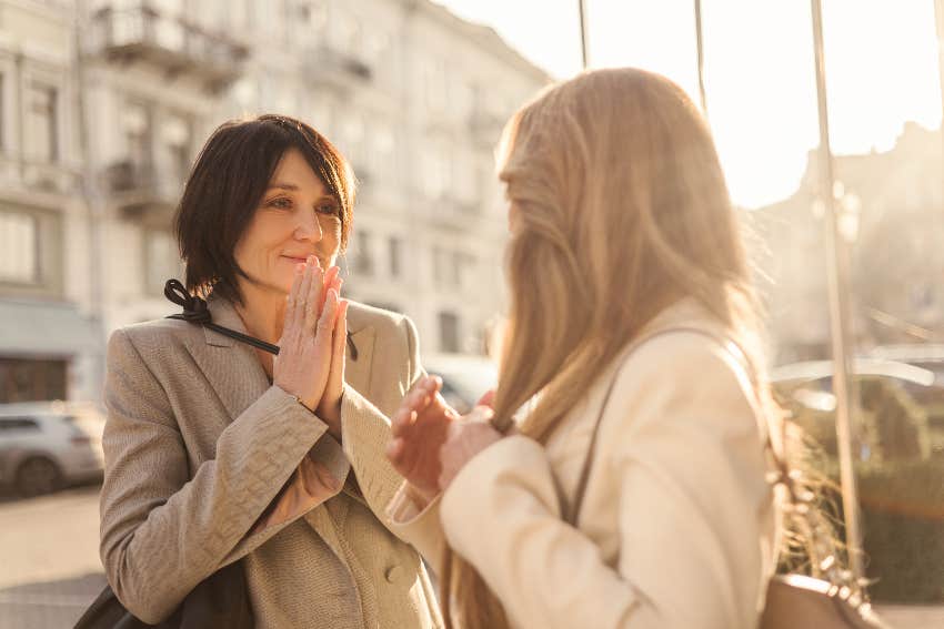 women talking to each other on the street