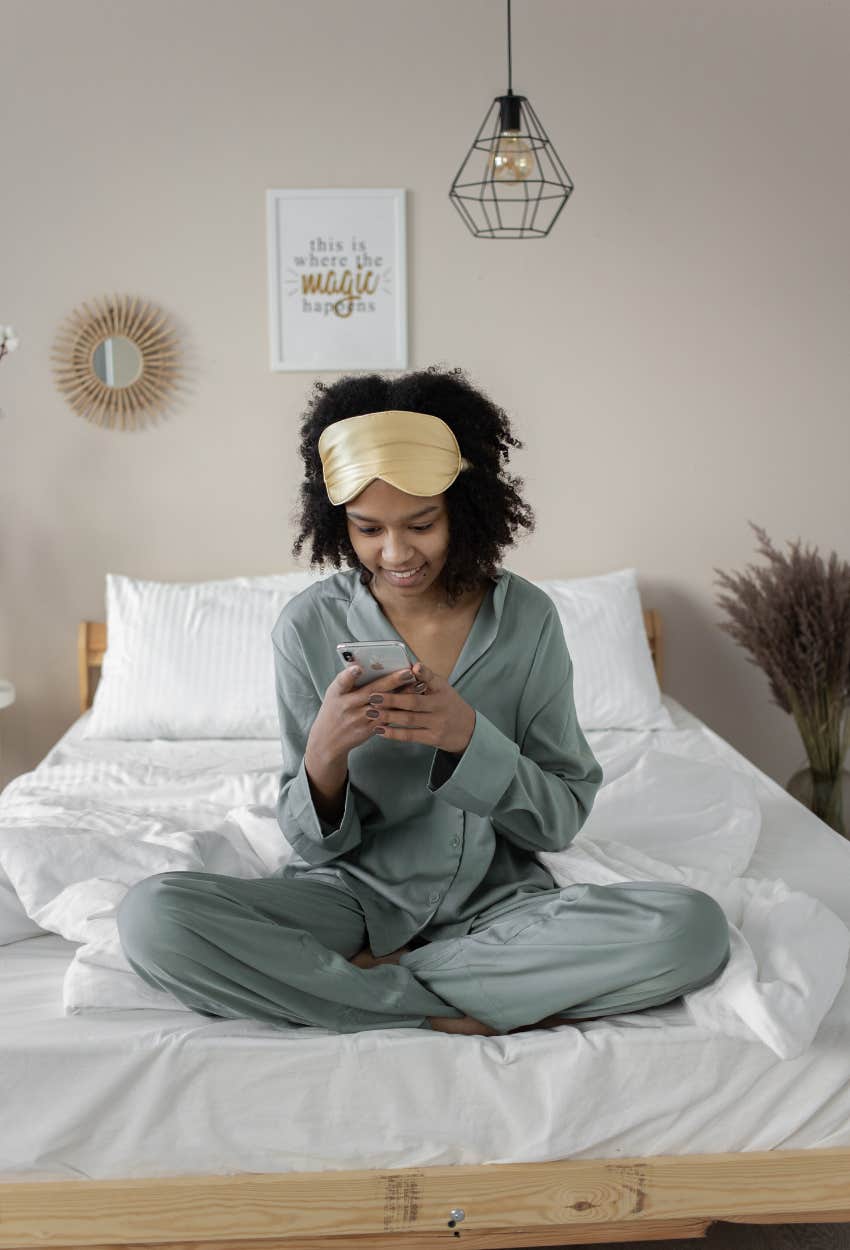 woman looking at her phone first thing in the morning