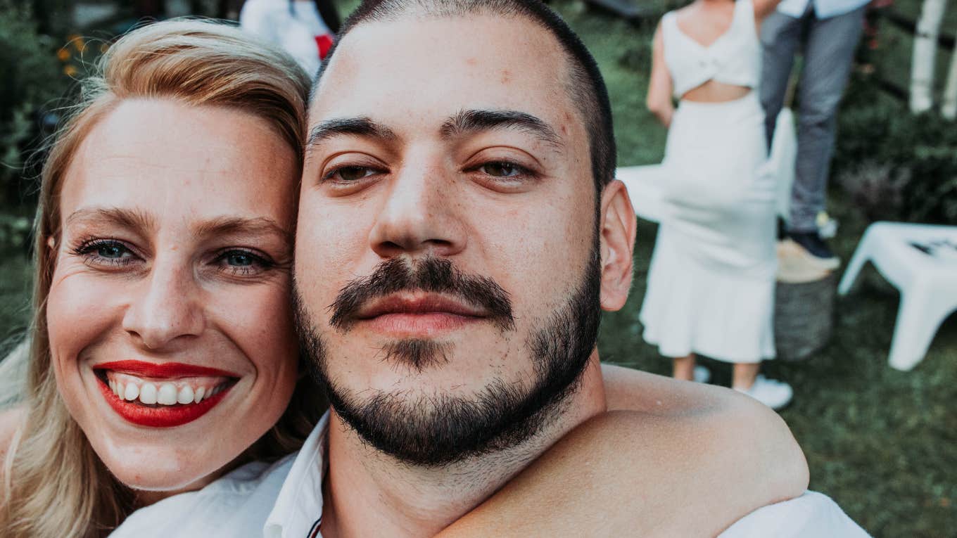 friends smiling for the camera at a wedding