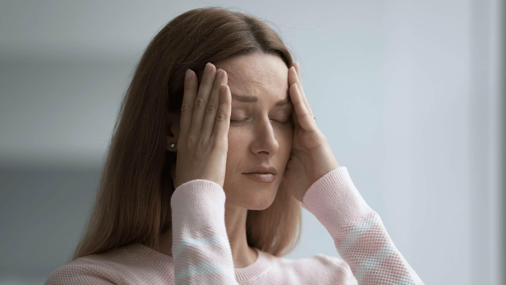 upset woman holding her head