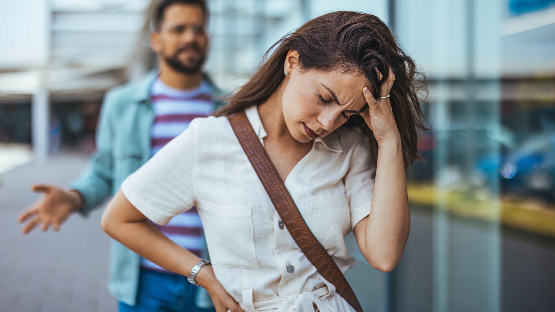 Woman turned away from her partner looking frustrated.