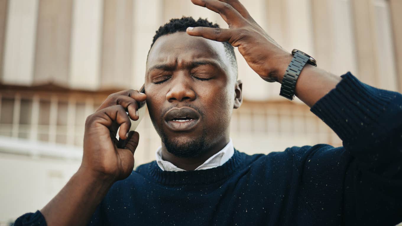 Man looking annoyed talking on the phone.