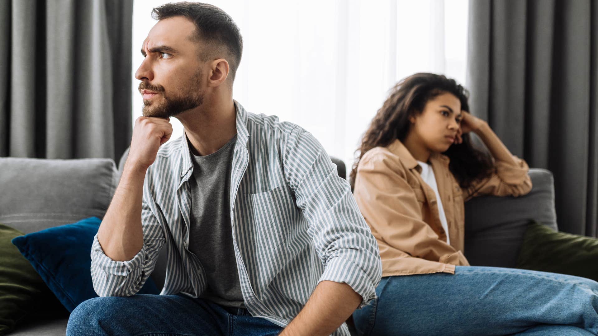 Annoyed man turned away from his wife