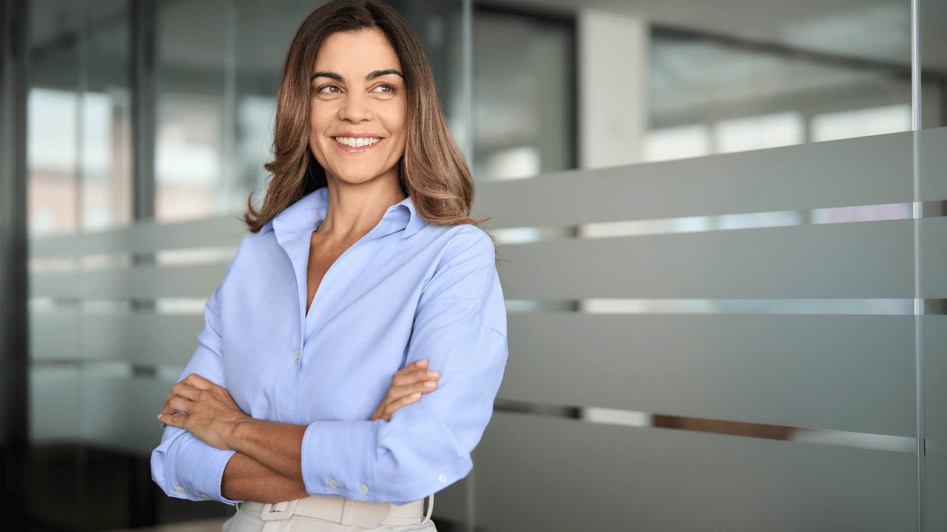 woman crossing arms while smiling