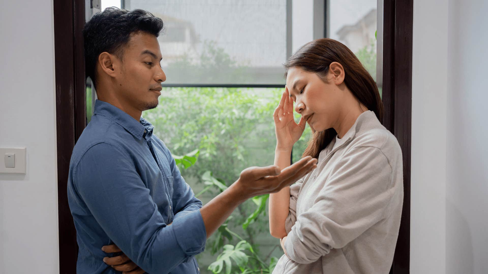 couple having serious argument in doorway