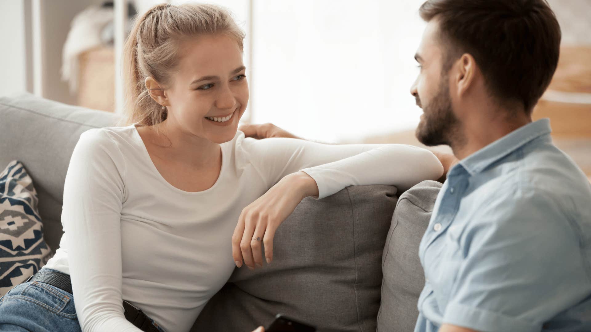 woman smiling as man talks to her