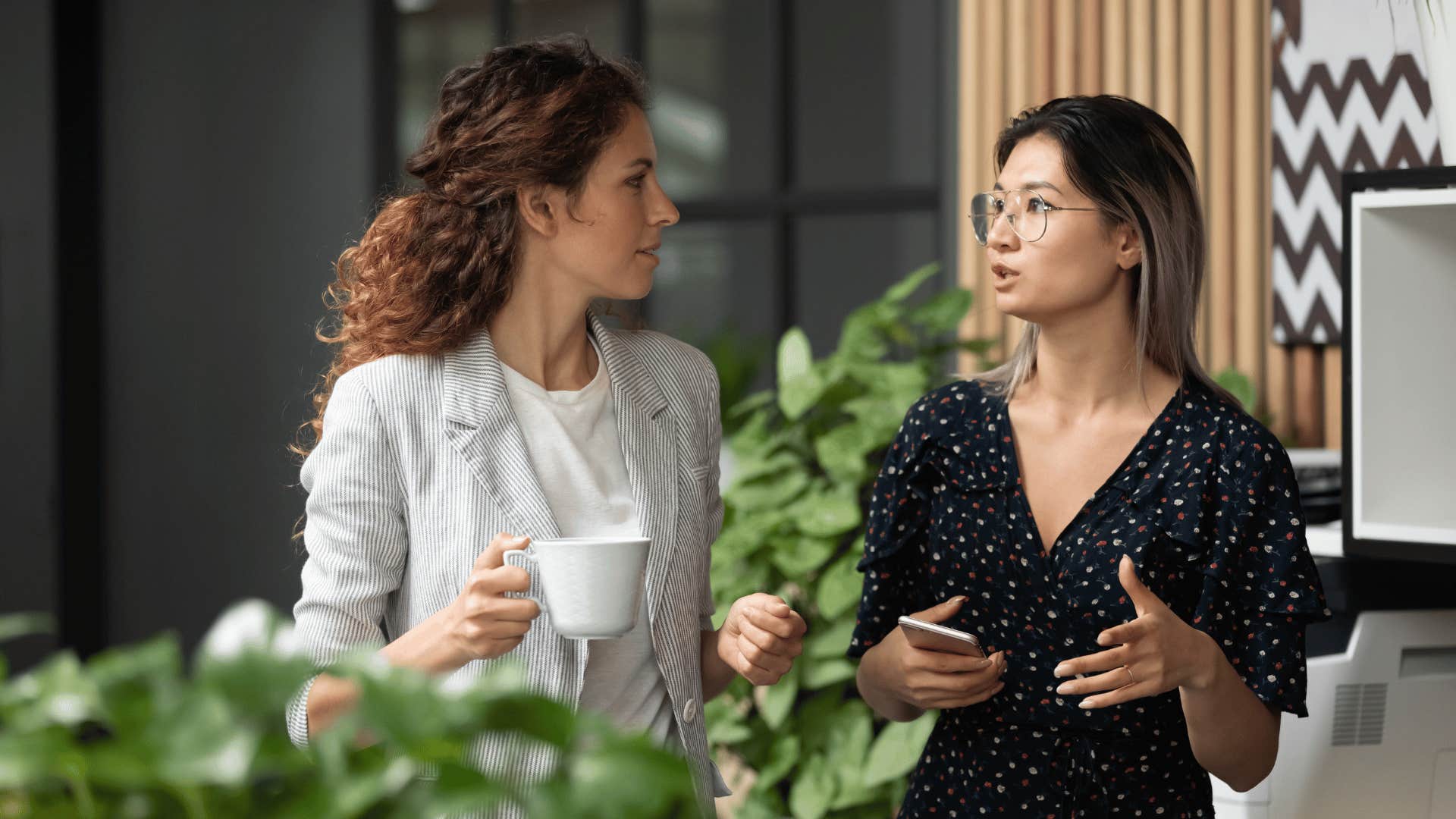 two coworkers talking while walking