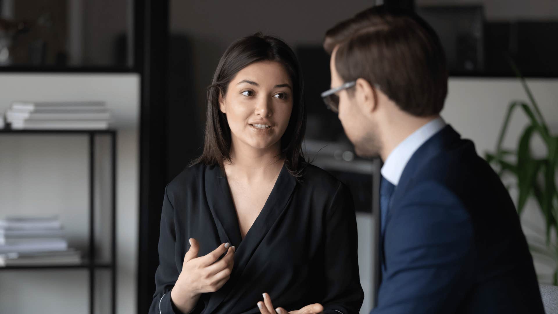 woman explaining something to man coworker