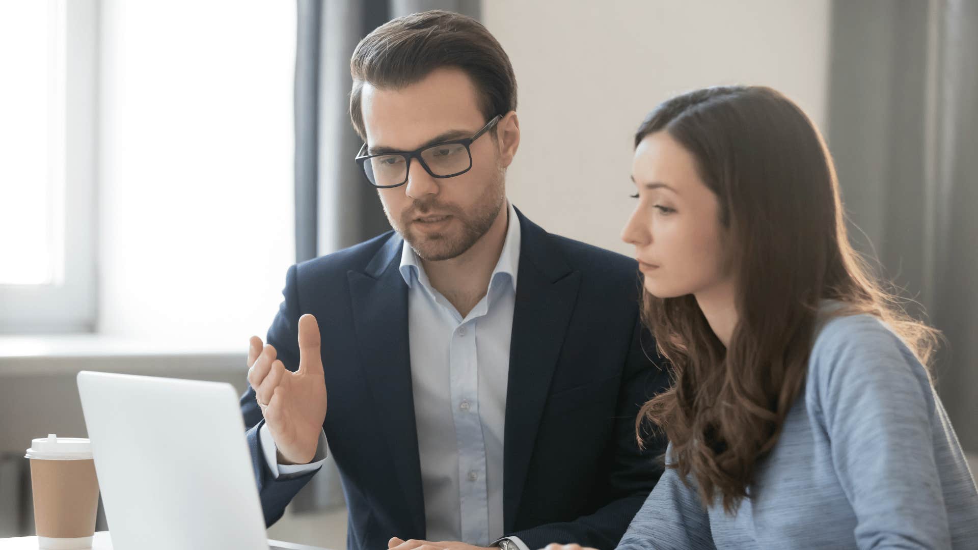 man explaining something to coworker