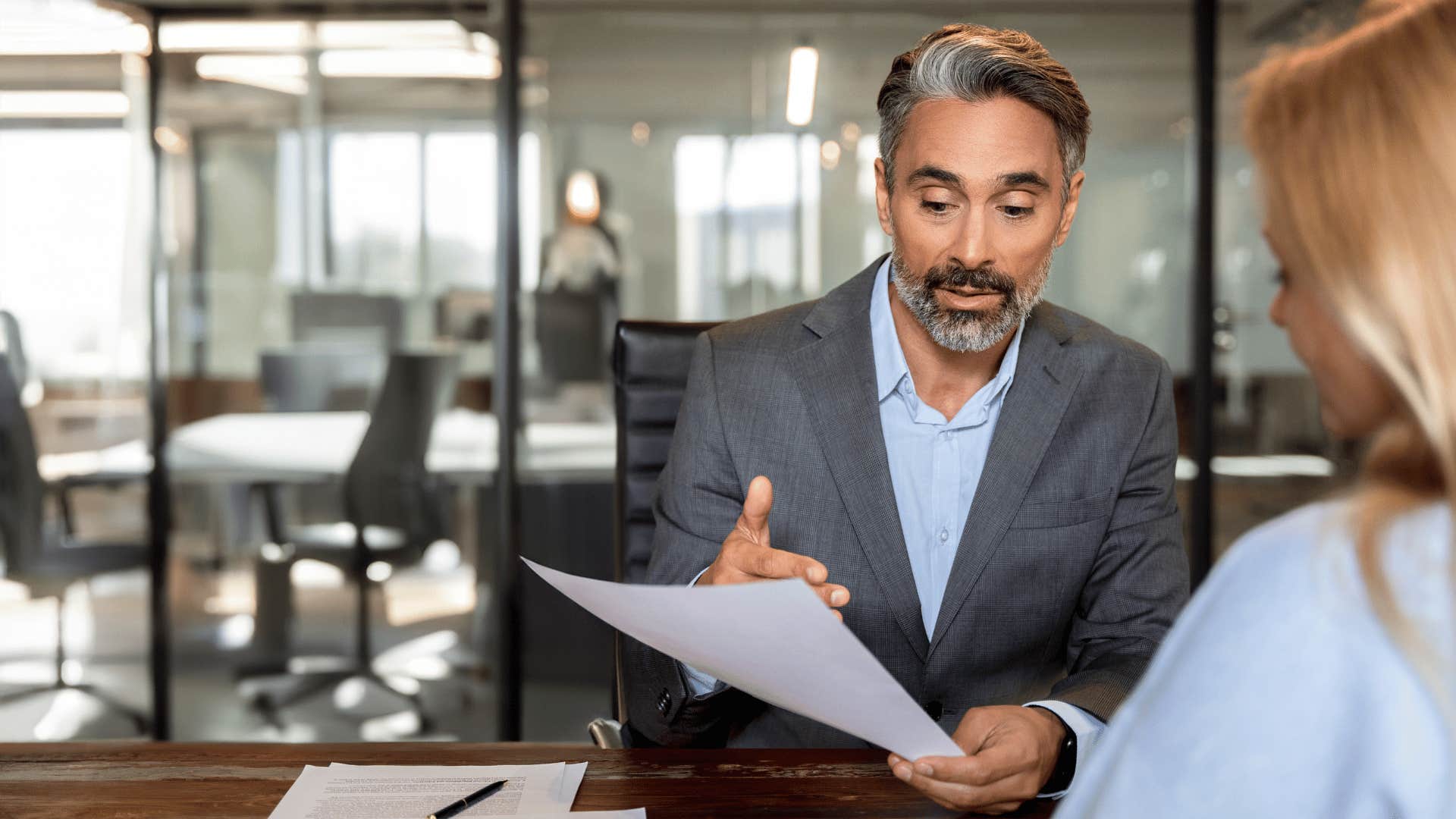 man pointing at paper