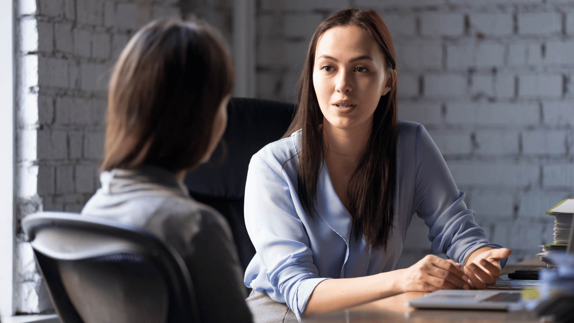 woman talking to coworker 