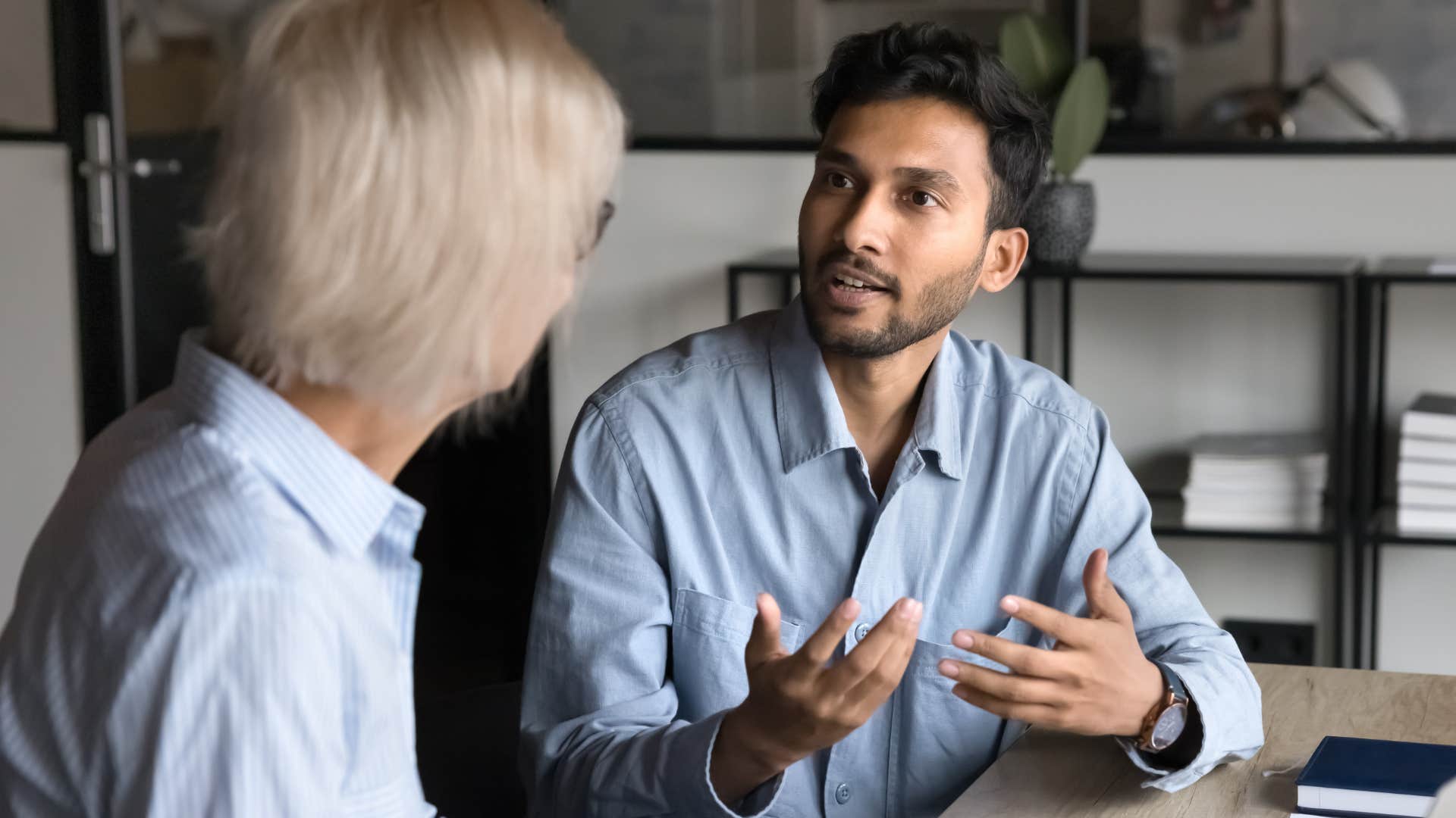 man questioning peer at work