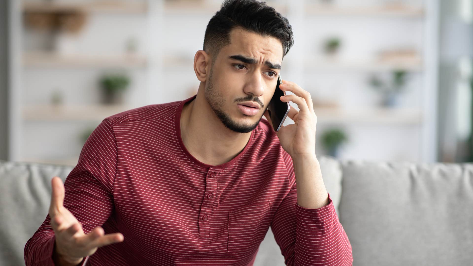 irritated man arguing on the phone