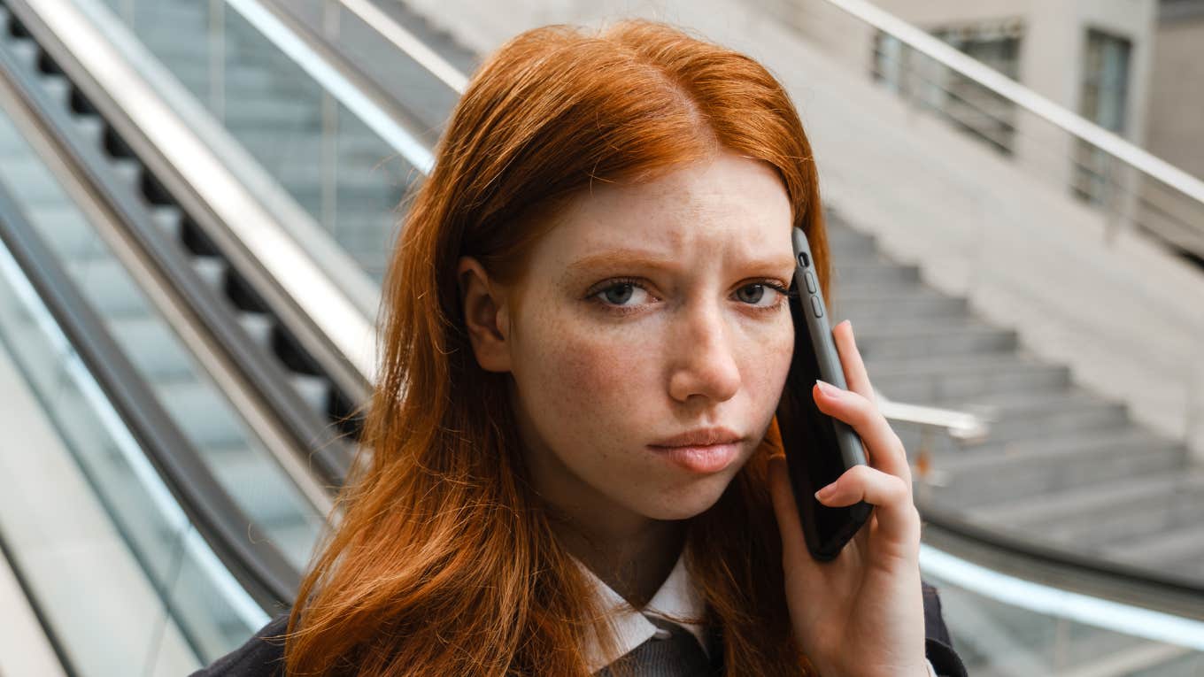 young woman on the phone looking annoyed