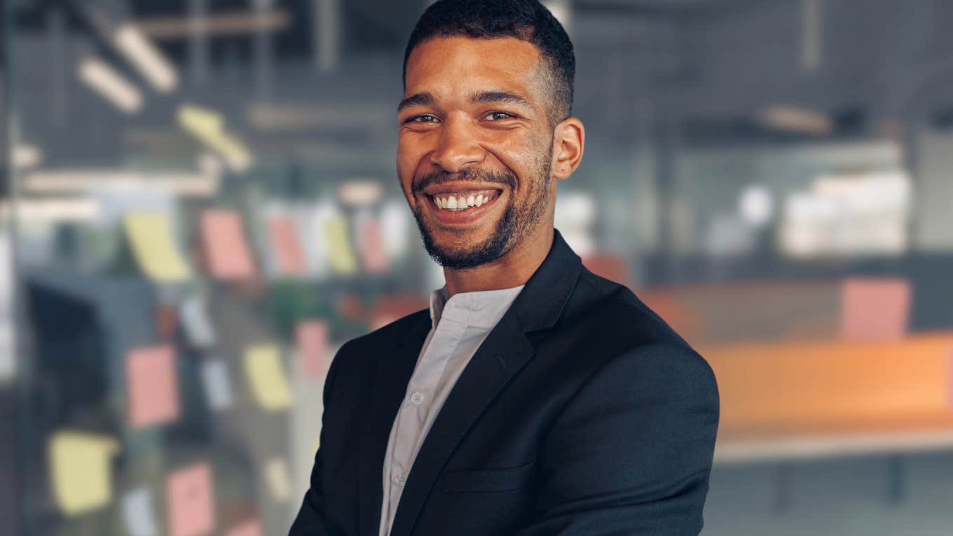 Professional man smiling at the camera in his office.