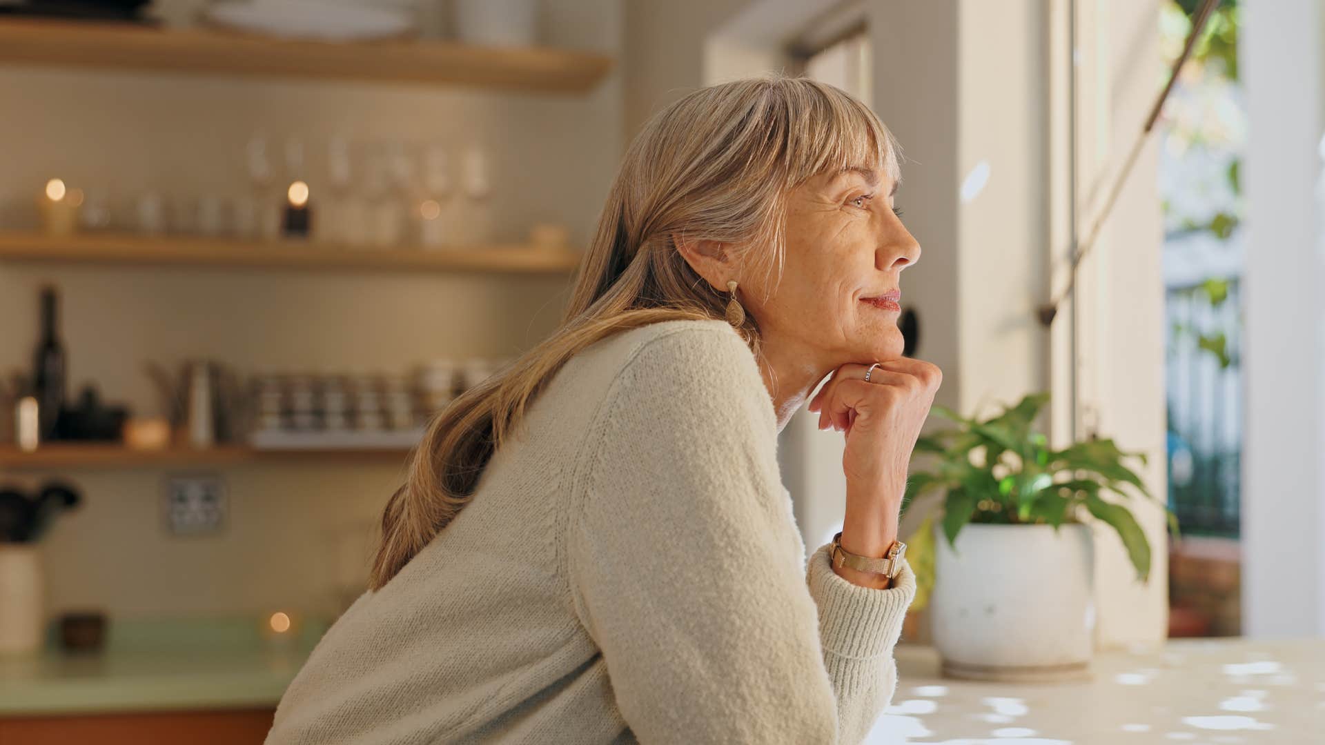 woman looking out kitchen window tired of argumentative men