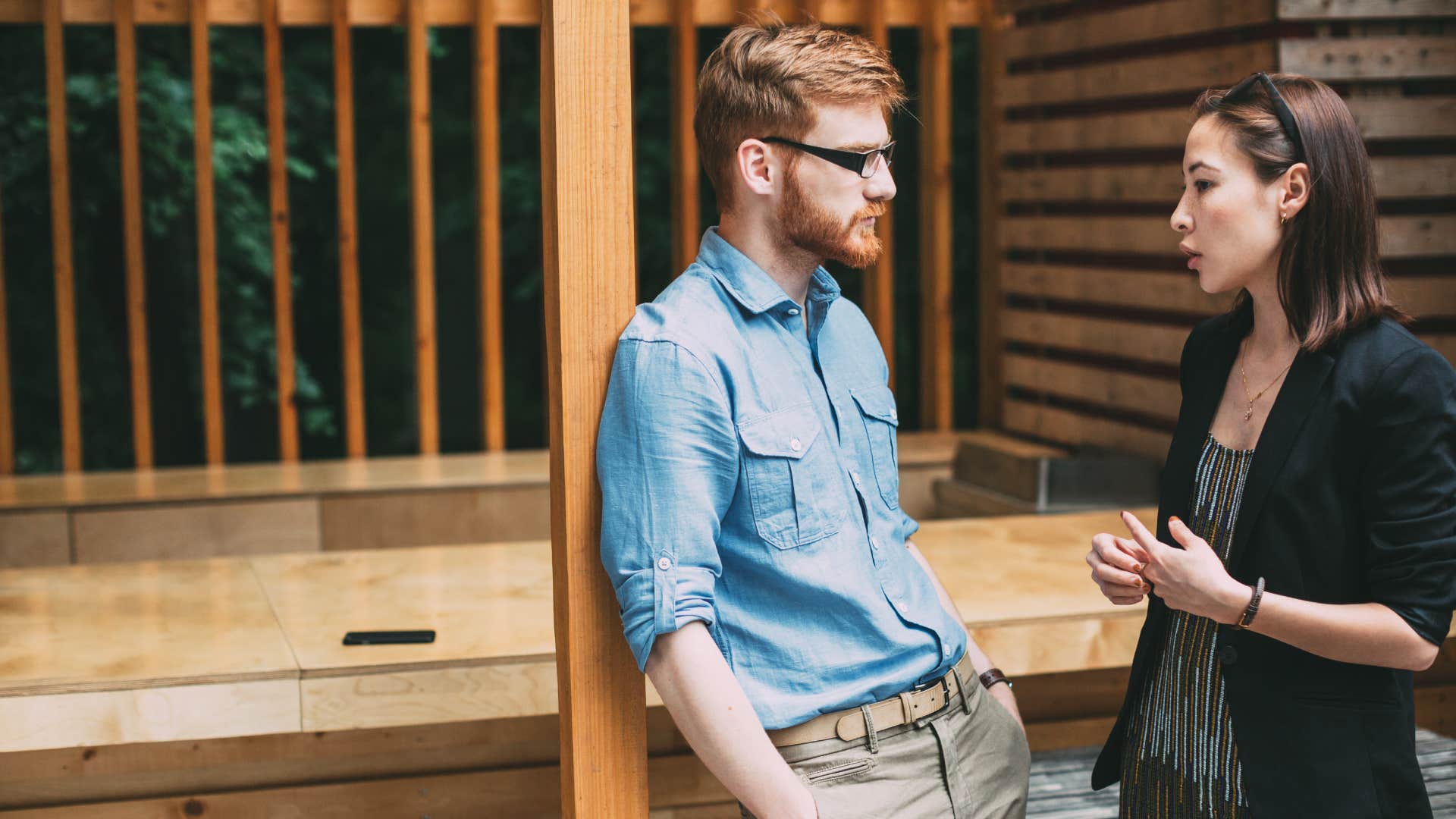 man and woman having discussion outside