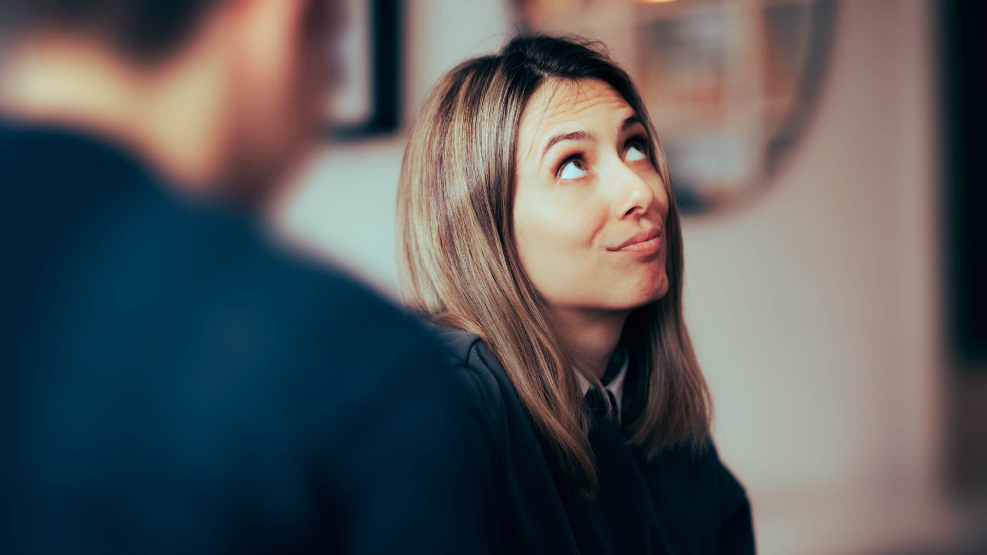 woman rolling her eyes during conversation with toxic man