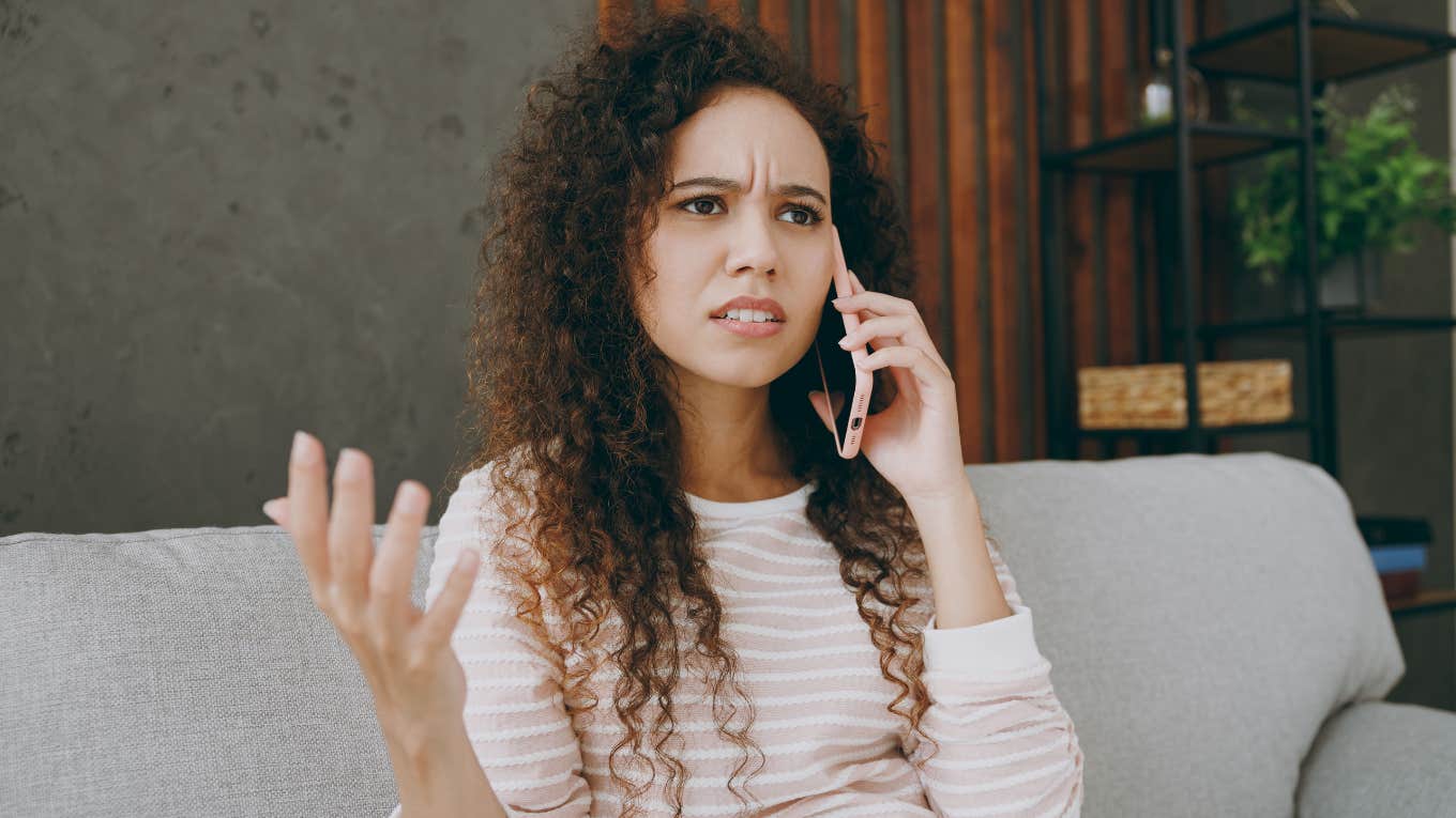 annoyed brilliant woman talking on the phone with someone