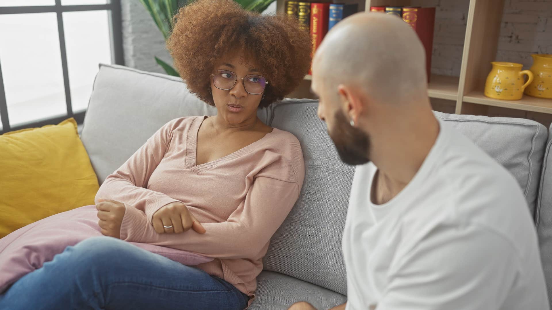 Woman looking annoyed talking to her partner.