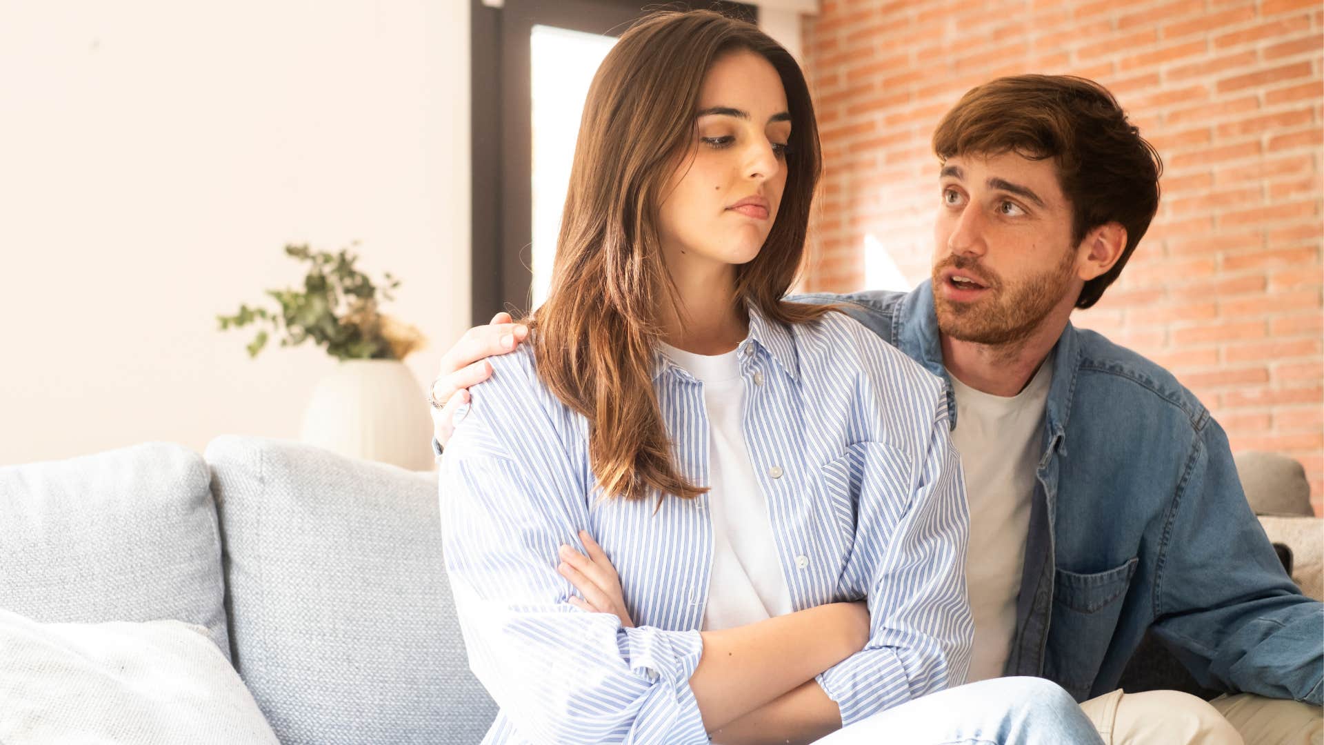 Woman looking annoyed next to her partner.