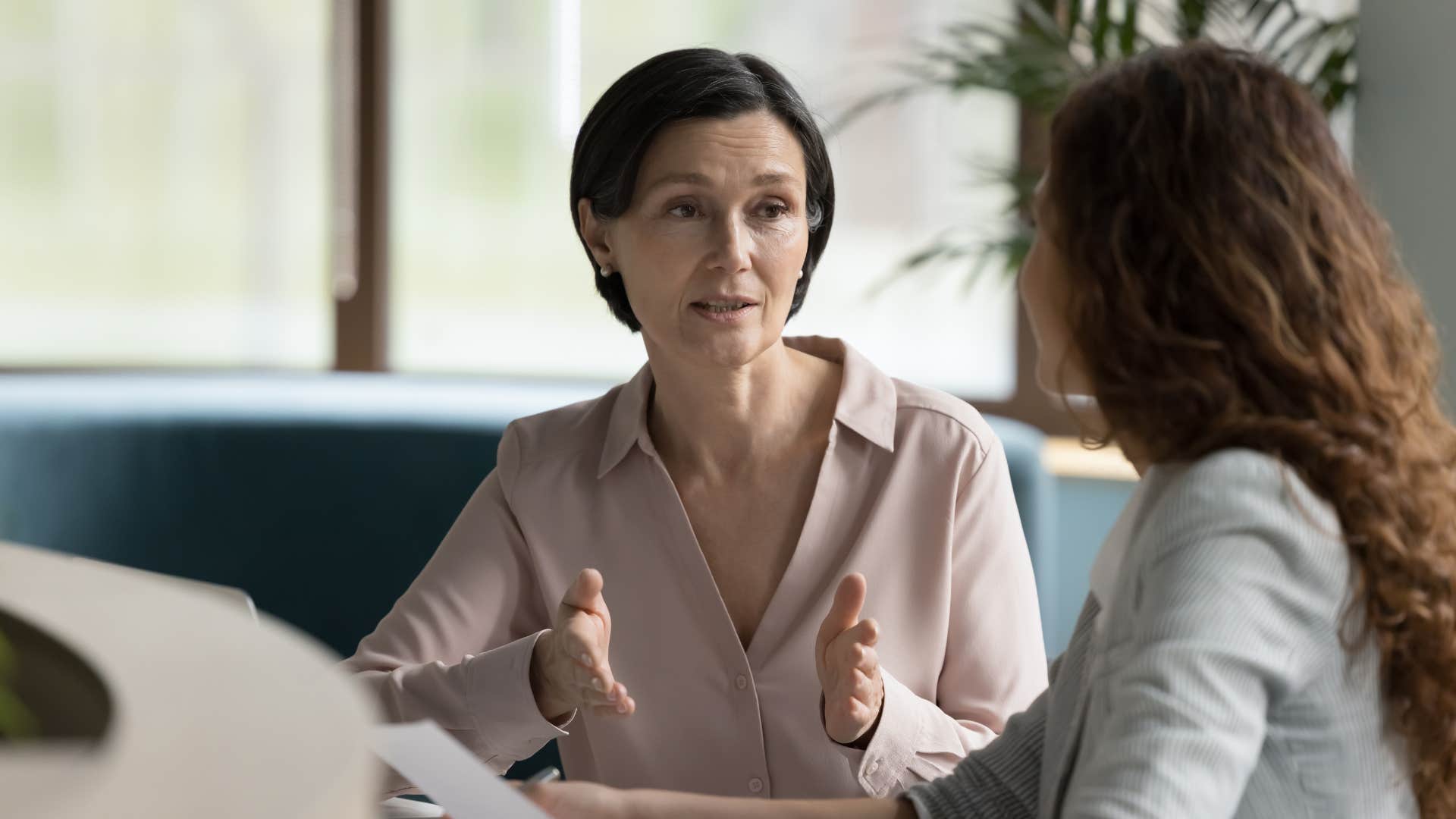 Woman having a serious conversation with a co-worker.