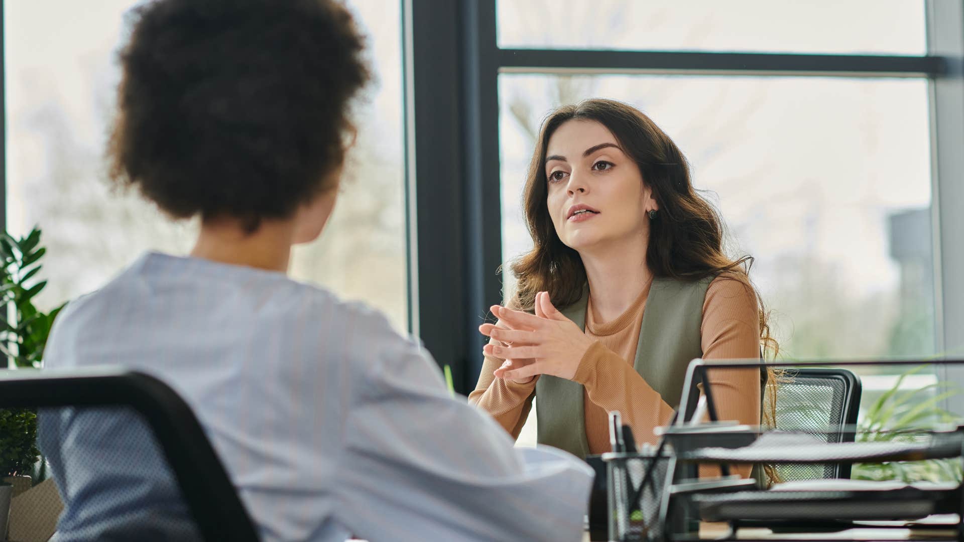 Co-workers having a serious conversation in an office.