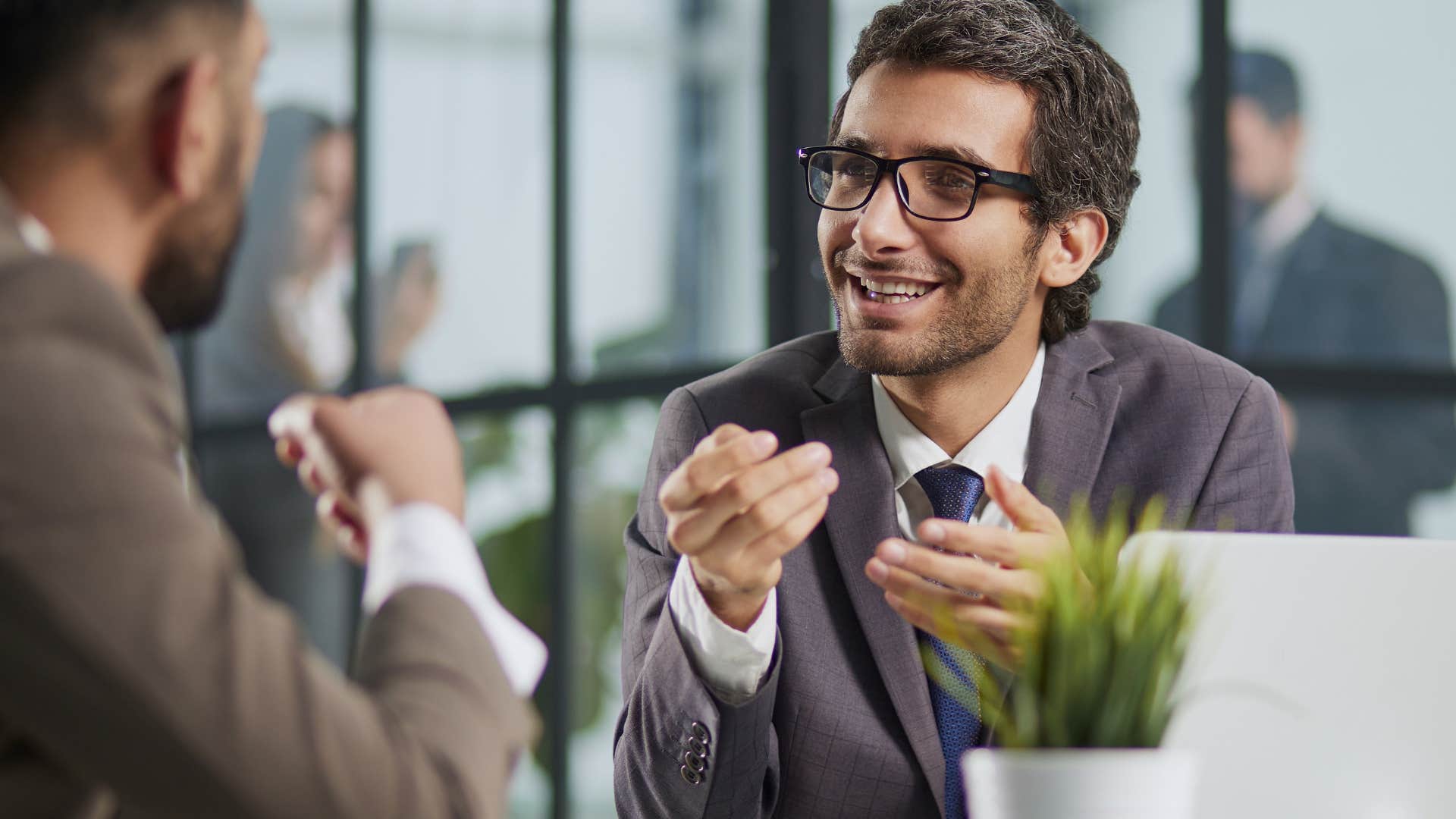 Two men having a conversation at work.