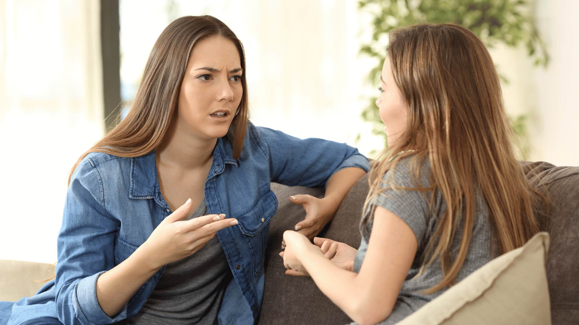 two women arguing on the couch