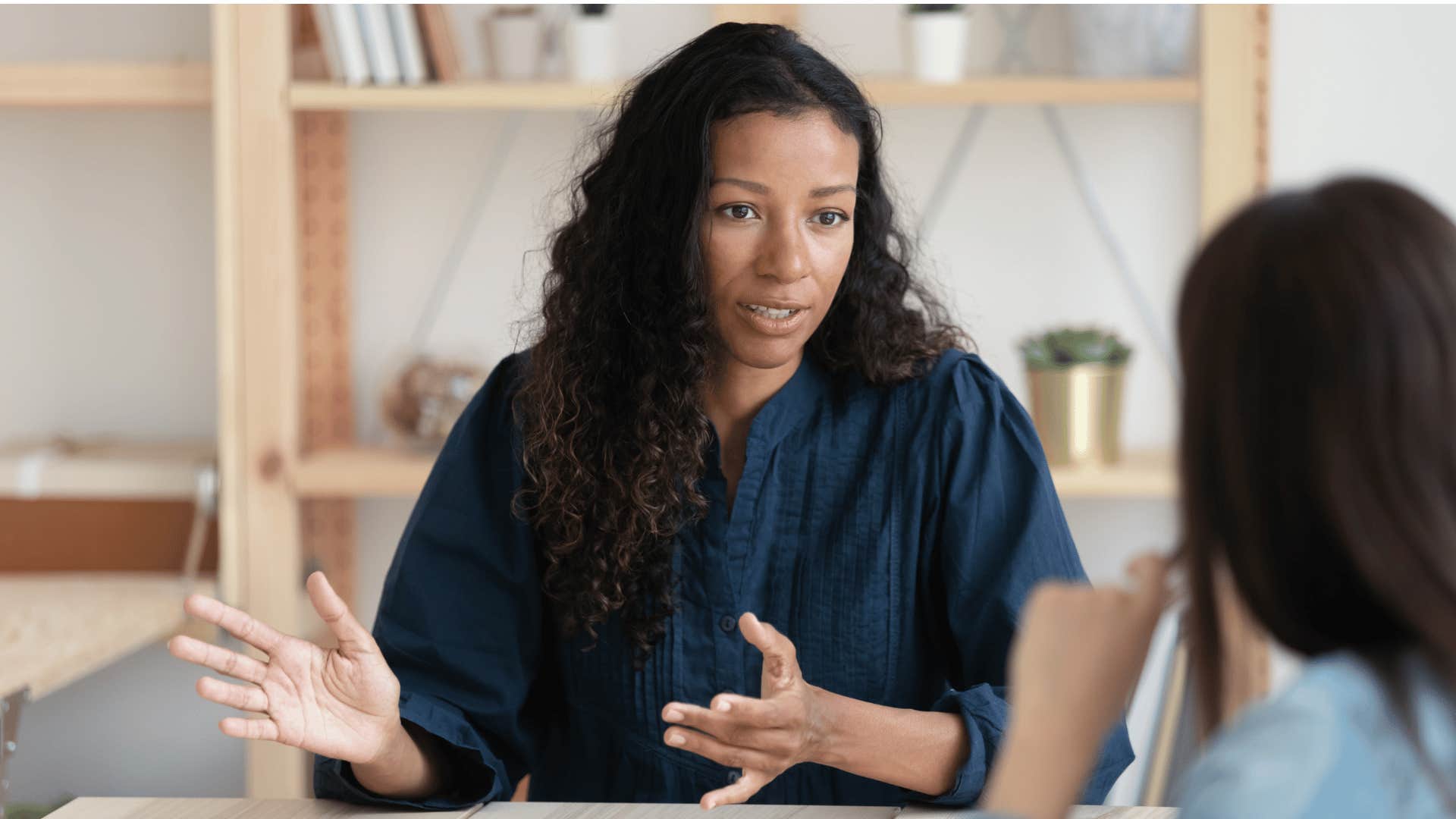 woman talking seriously to other woman