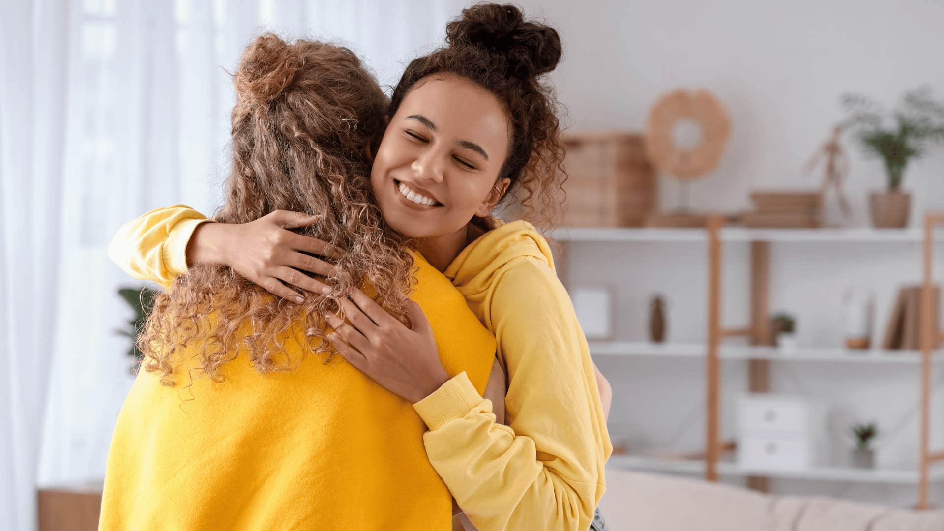 two women hugging 