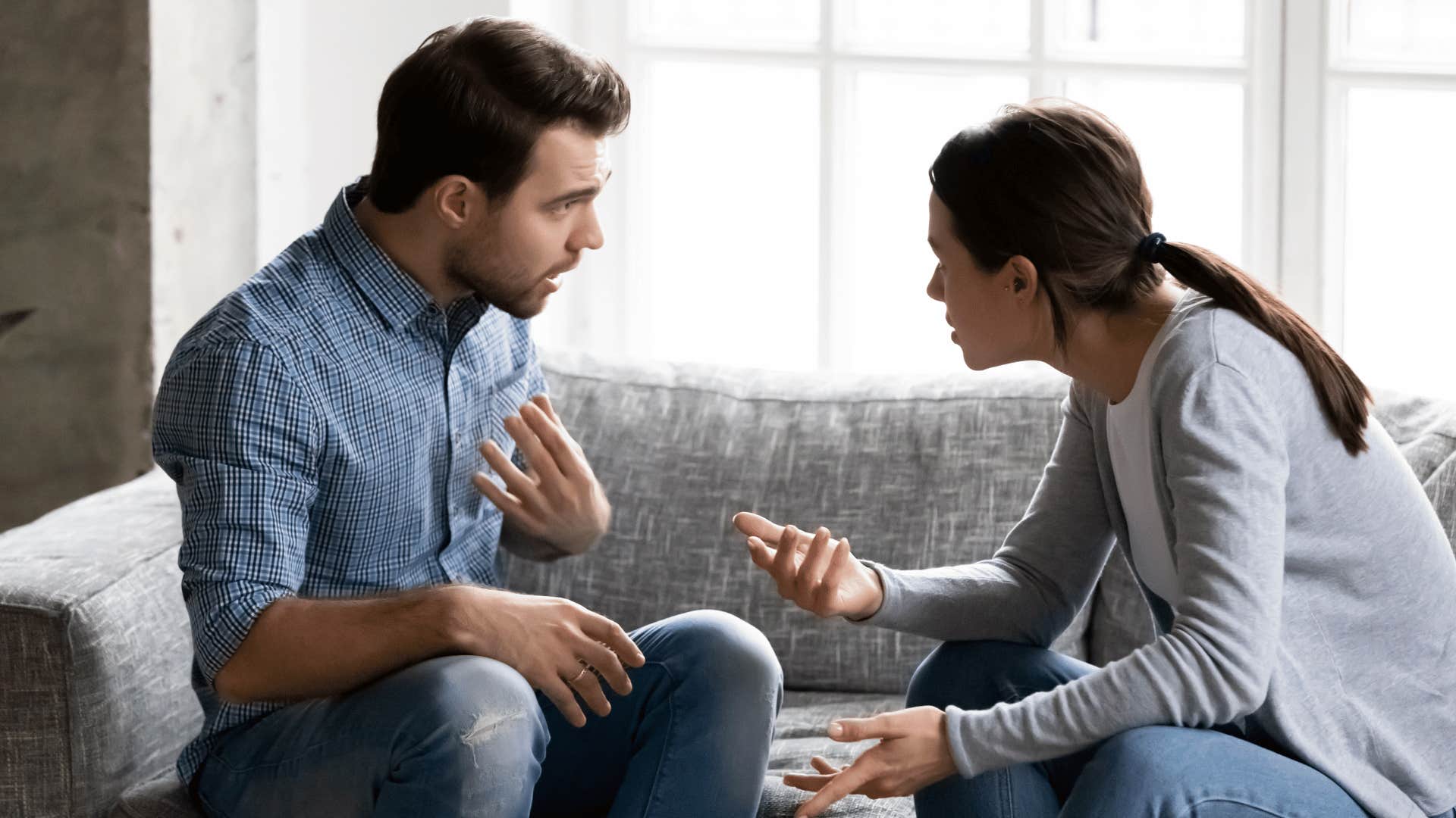 couple arguing on the couch