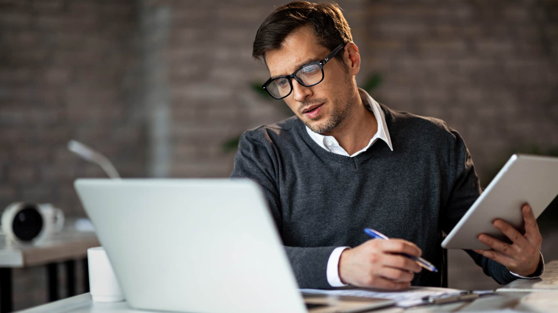 Multi-tasking businessman working in the office