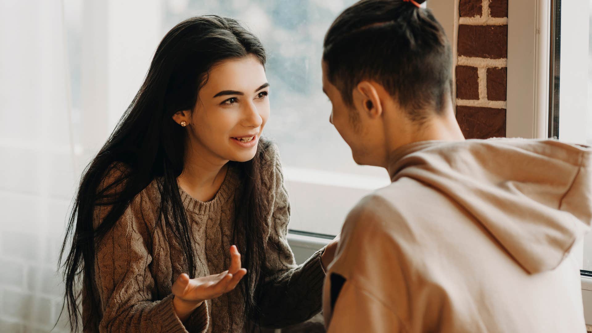 Smiling woman talking to her partner. 