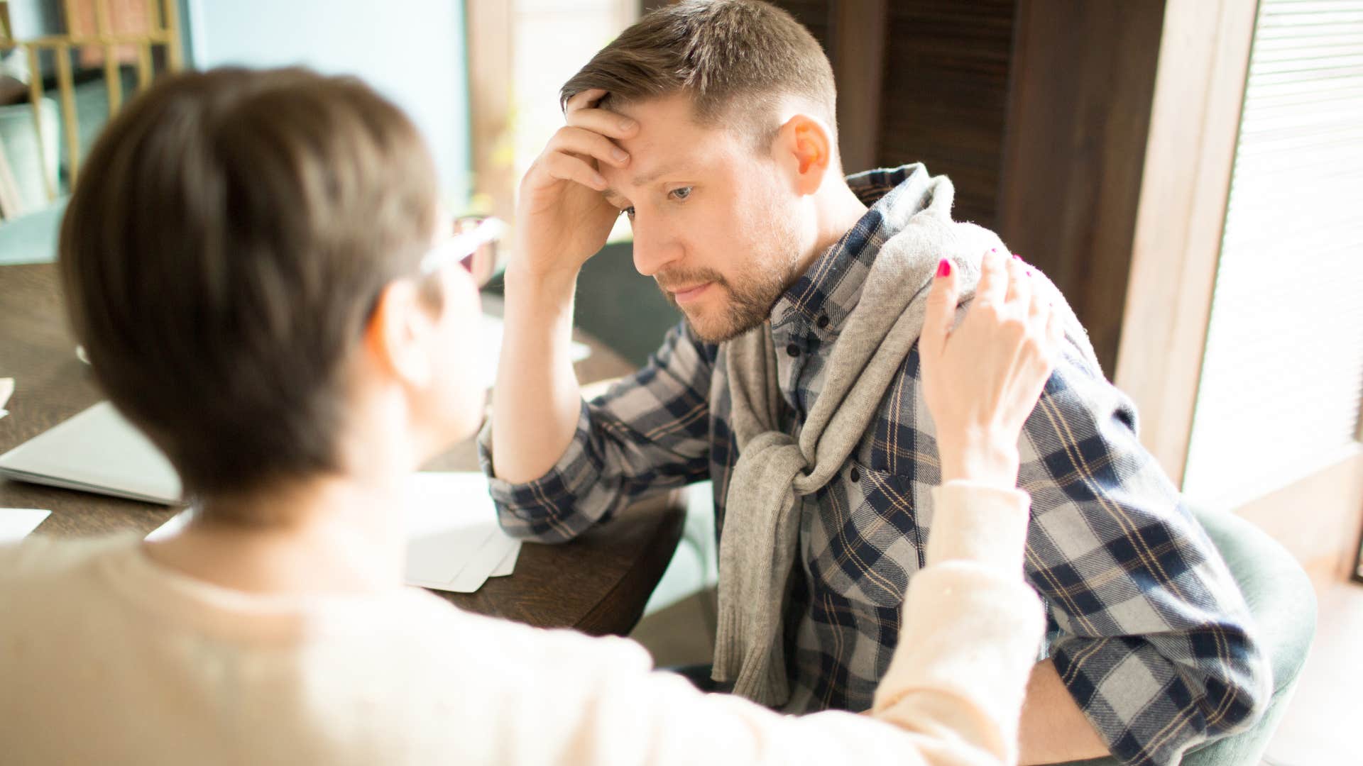 Woman comforting her upset partner.