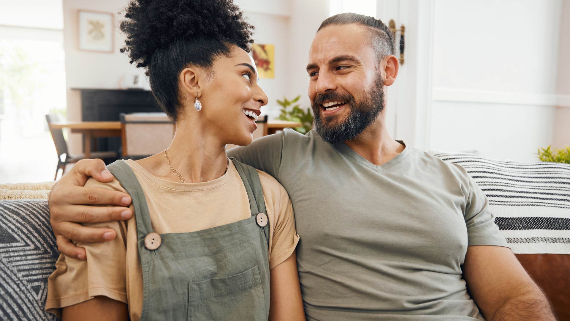 Woman and her partner smiling and hugging.