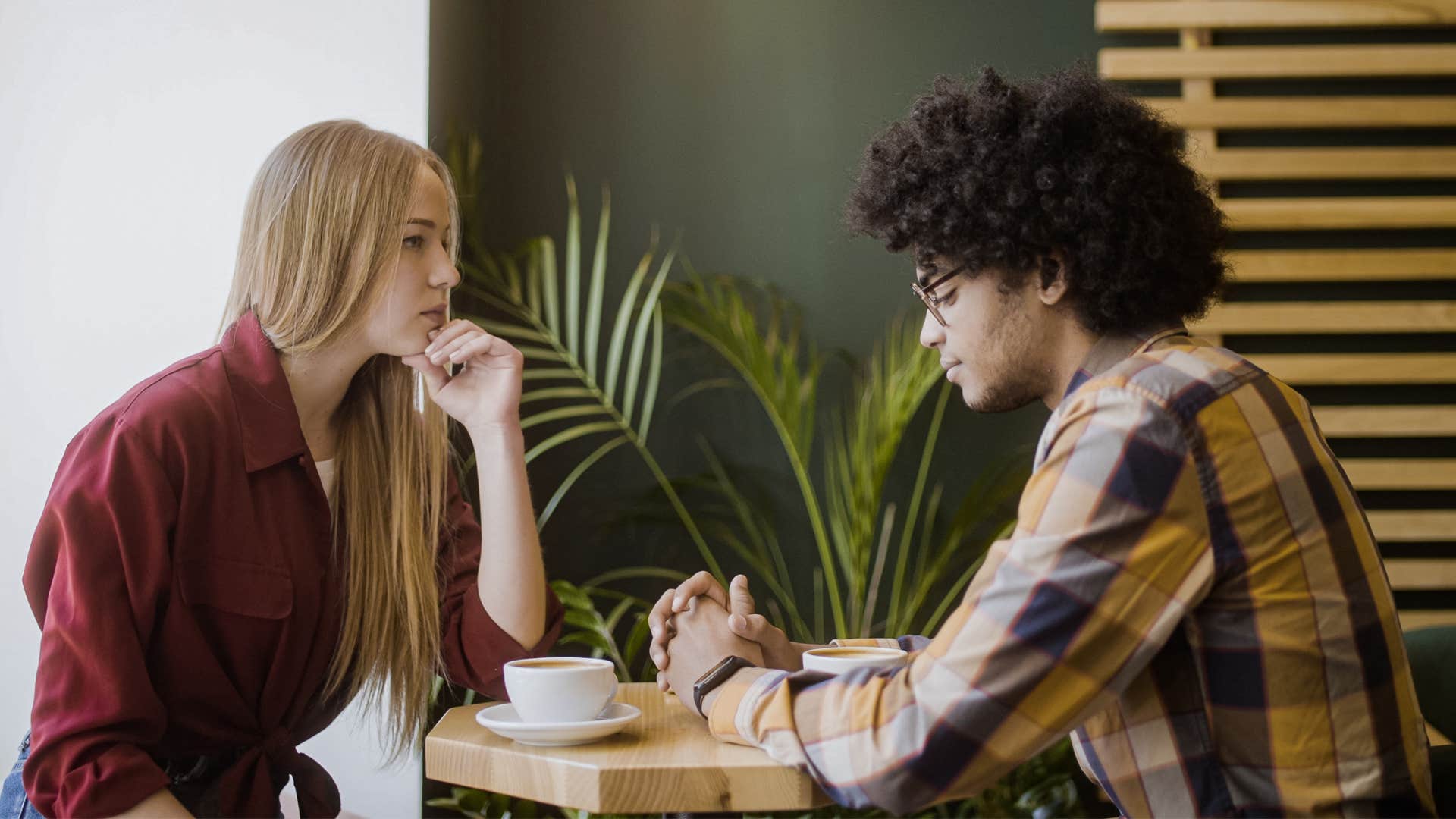 Couple sitting at a table having a conversation.