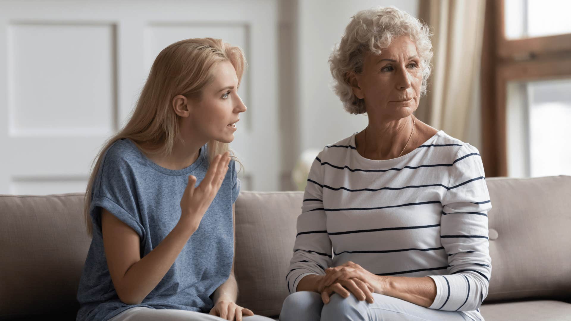 woman arguing with mother on couch