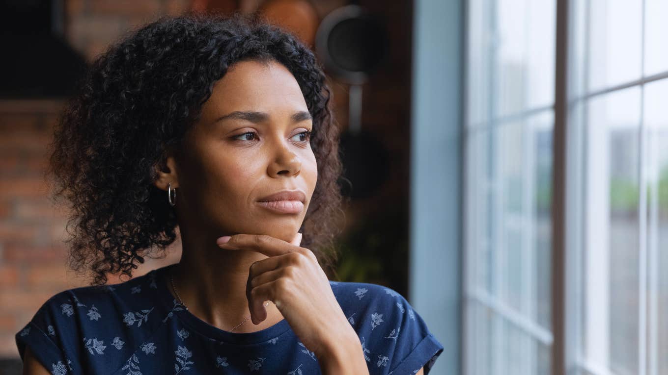 confused woman thinking and looking outside