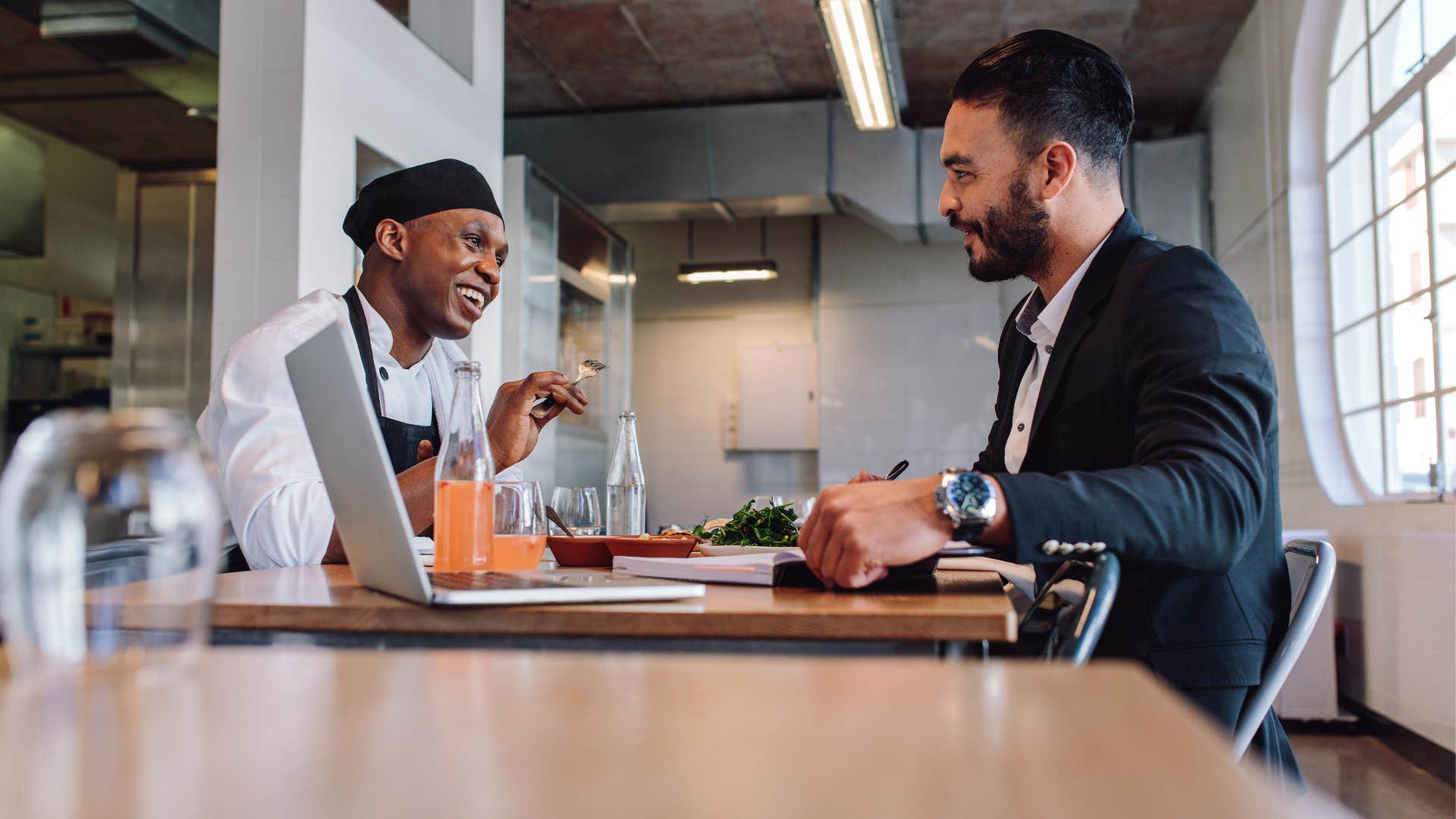 businessman talking to chef at restaurant