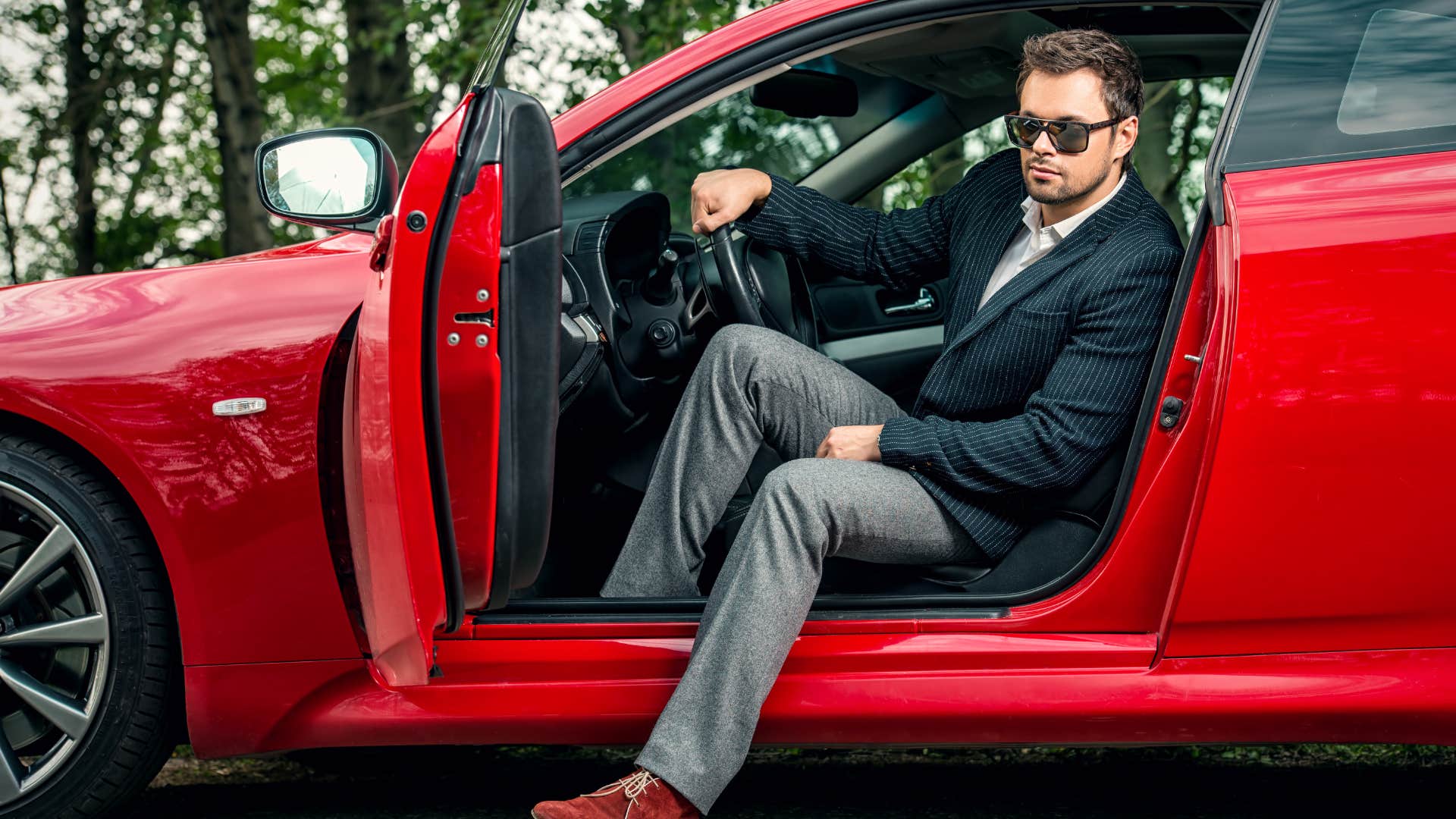 man sitting in luxury car