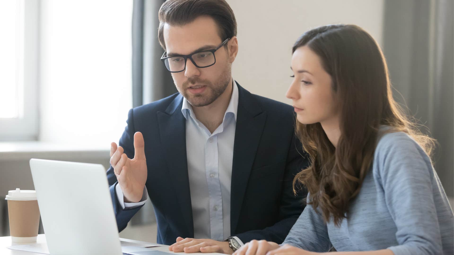 man explaining something to woman