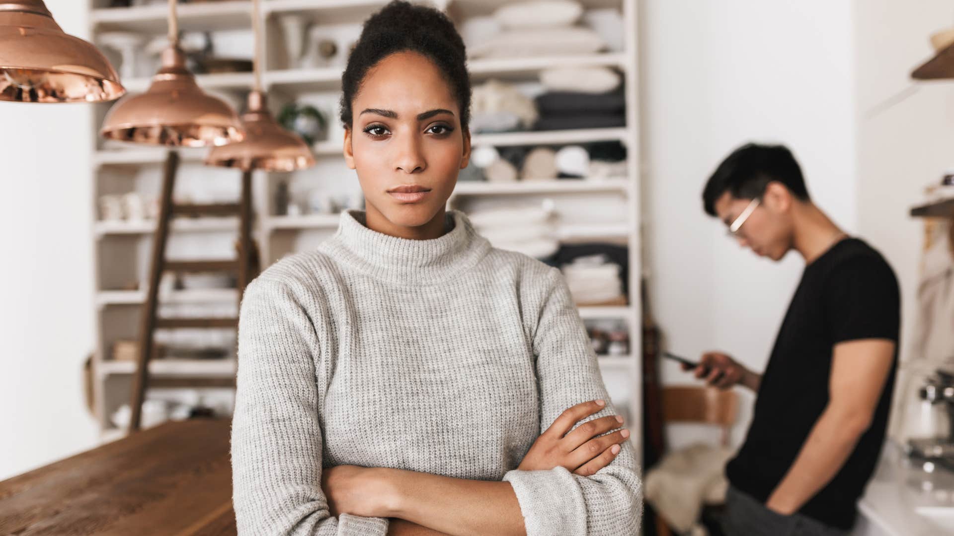 Woman looking upset and crossing her arms.