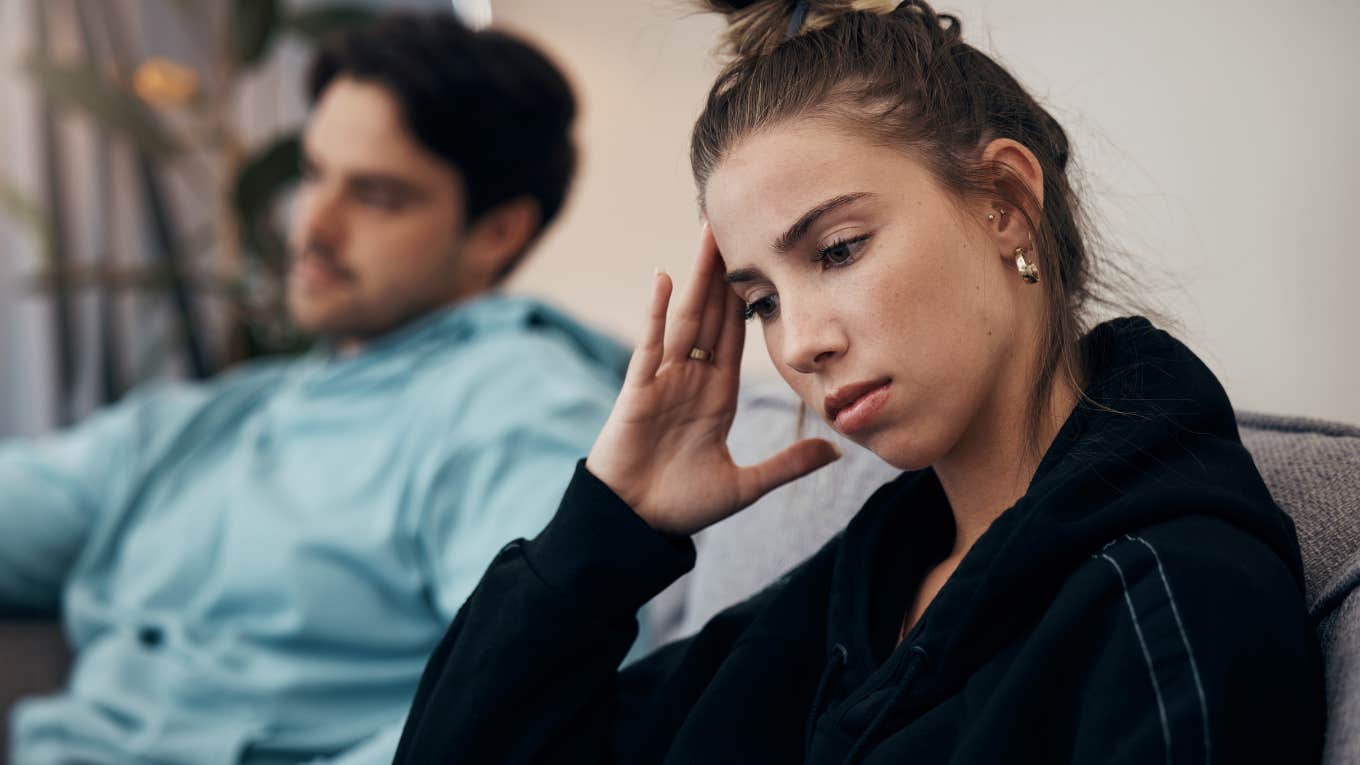 Woman turned away from her partner looking upset.