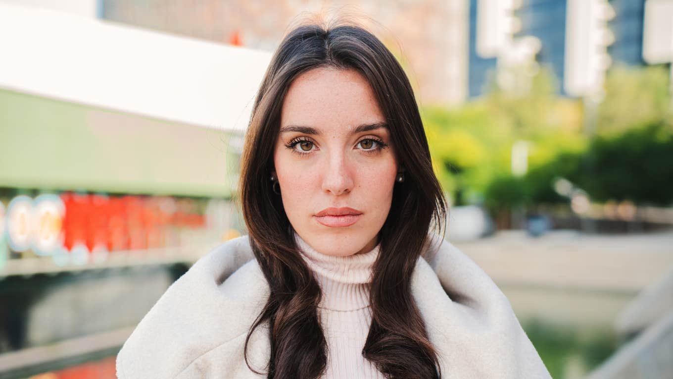 Front view of serious young woman looking at camera. 