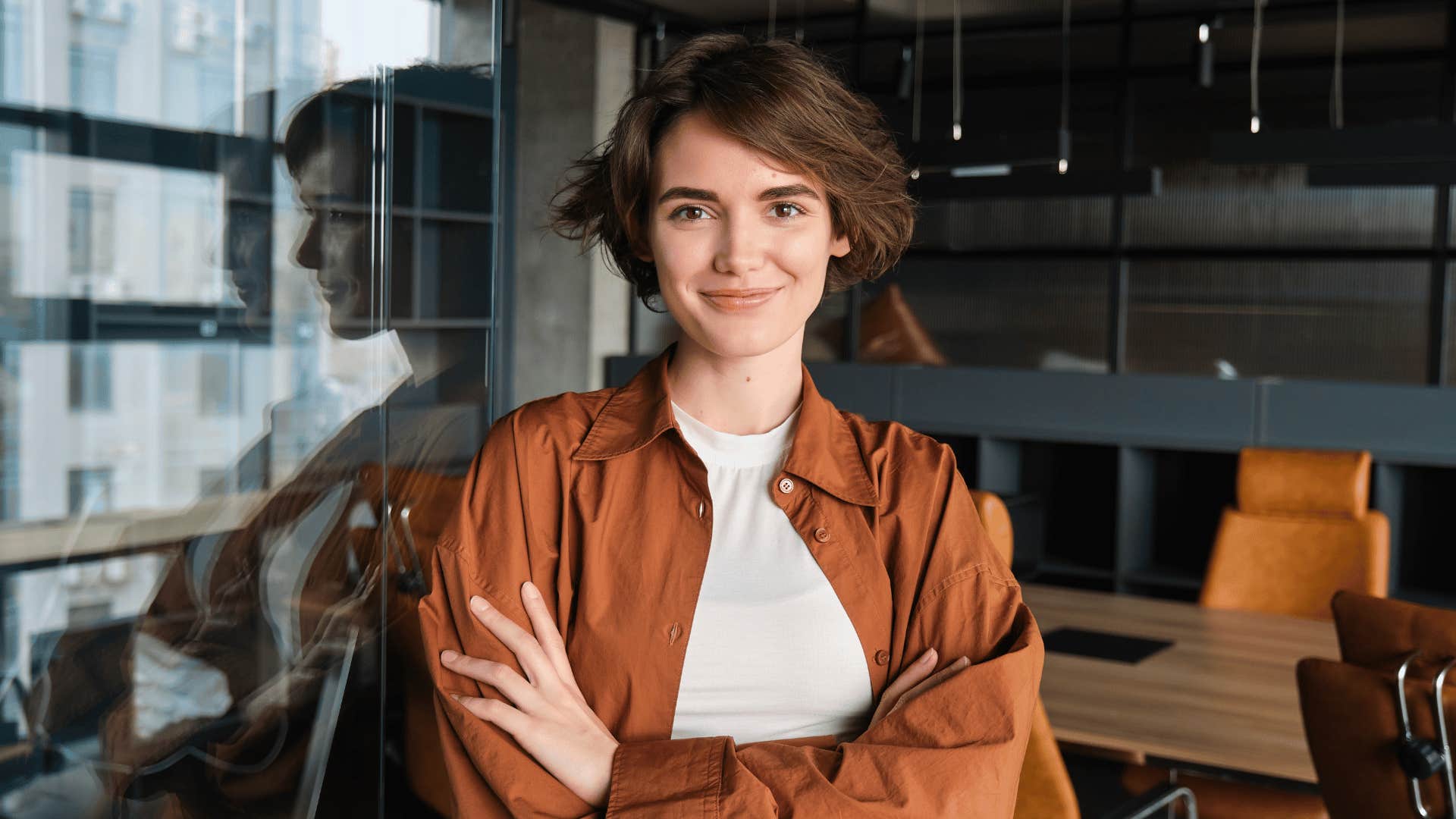 woman crossing arms and smiling at camera