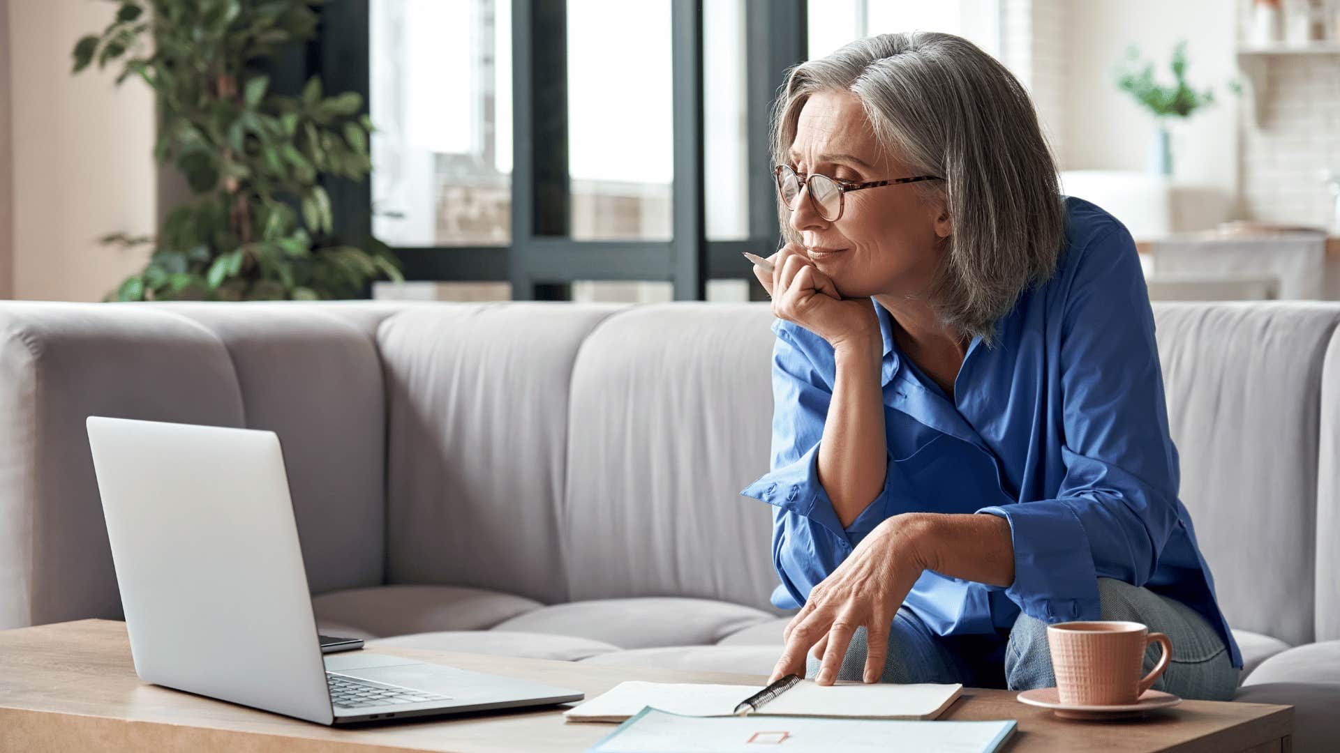 woman staring at laptop while working